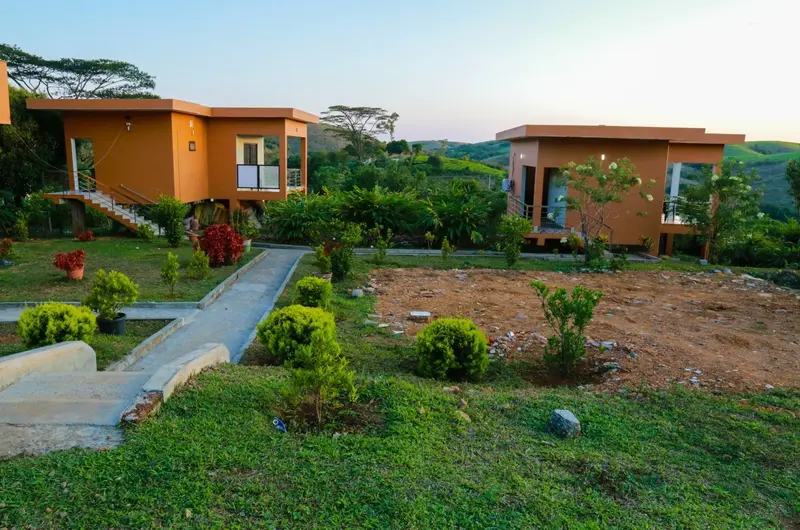 Resort cottage with paved walkway and manicured green lawn at Cee Cee Grand Resort Vagamon