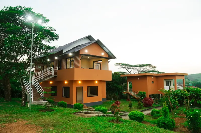Resort cottage exterior surrounded by lush trees and greenery at Cee Cee Grand Resort Vagamon