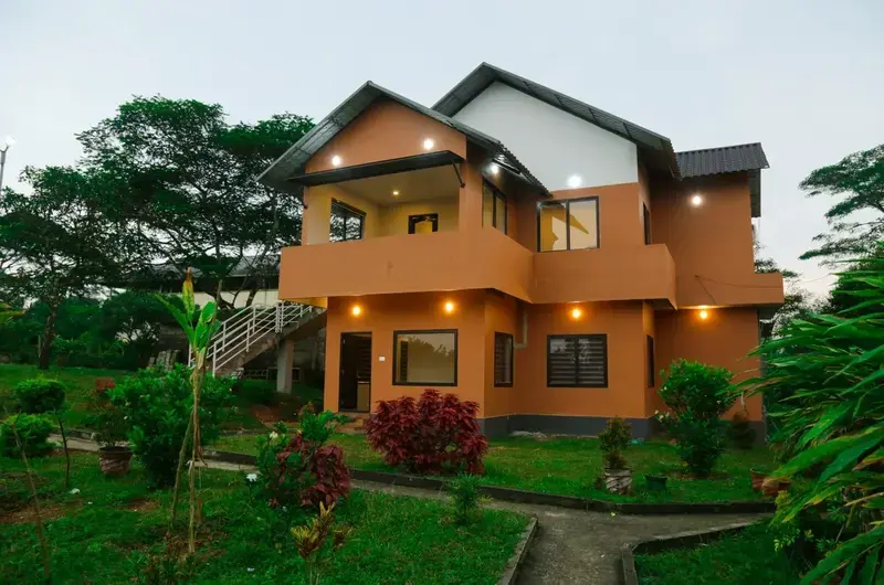 Multi-story resort building with paved garden path at Cee Cee Grand Resort Vagamon