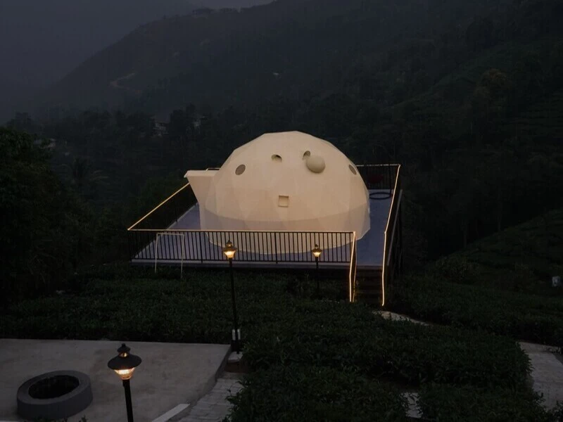 Warmly illuminated geodesic dome glamp at night at Pendora Glamps Vagamon