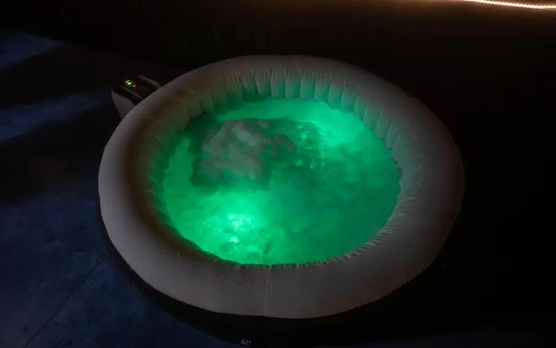 Illuminated outdoor jacuzzi plunge pool at night at Pendora Glamps Vagamon