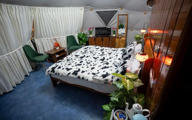 Comfortable double bed setup inside glamping dome at Pendora Glamps
