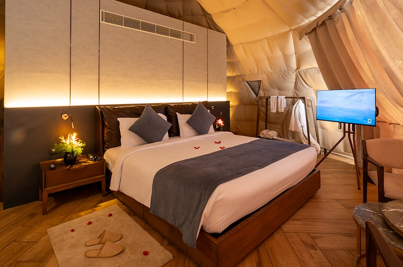 Elegantly designed glamping dome suite with double bed at Monticle Glamps