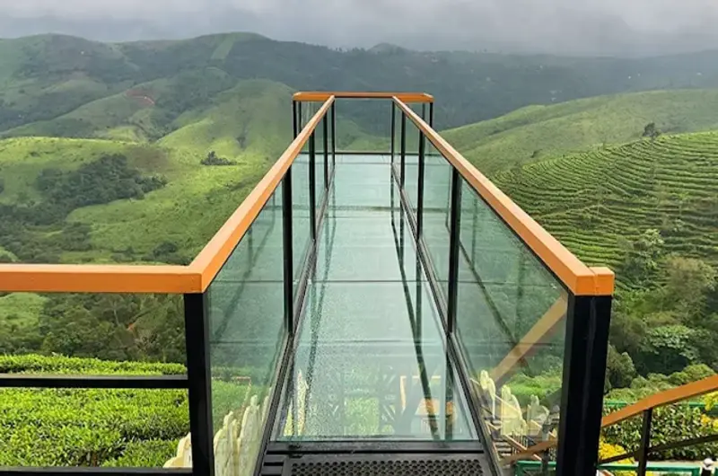Glass skywalk bridge offering scenic mountain views at The Felmel Resort