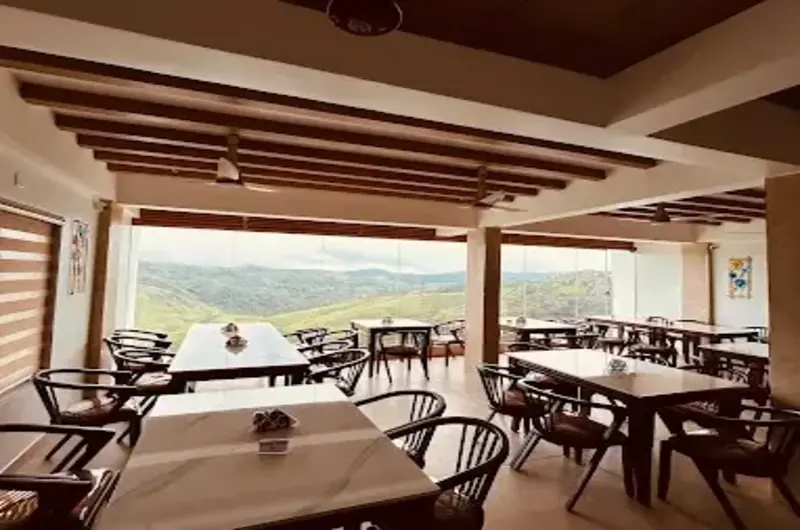 Open-air dining area and restaurant setup overlooking mountain views at The Felmel Resort