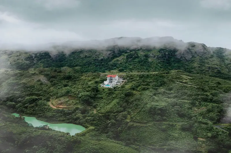 Mist-covered green hills and panoramic valley view near Le Collines Resort Vagamon