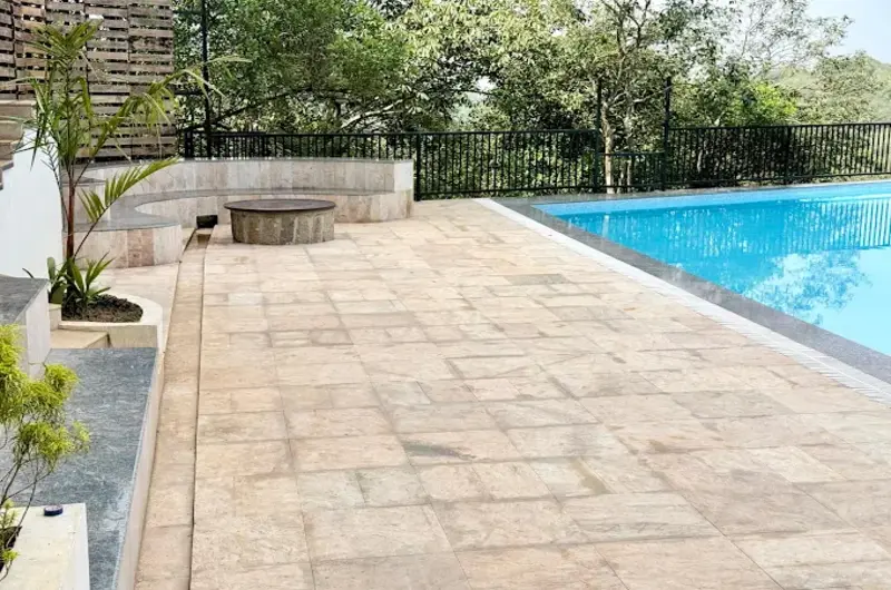 Outdoor swimming pool and paved sun deck area at Vanaheim Resort Vagamon