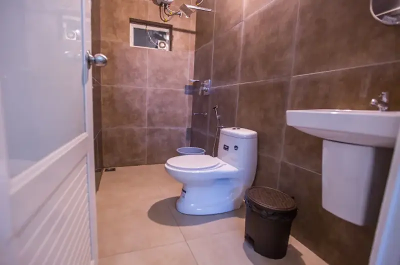 Clean modern attached bathroom with modern wash basin and toilet at Nexstay Mount Tales Vagamon