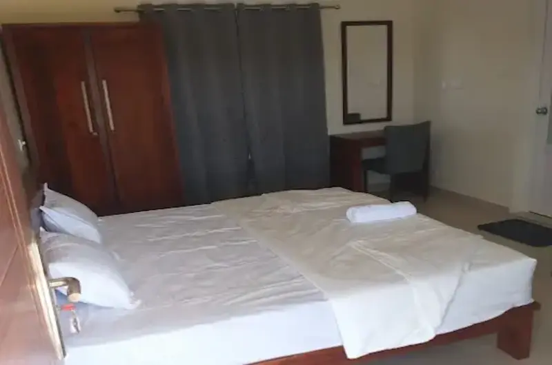 Comfortable guest bedroom with double bed and vanity desk at Nexstay Mount Tales Vagamon