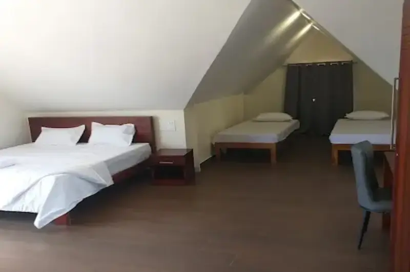 Spacious wooden attic bedroom suite with multiple beds at Nexstay Mount Tales Vagamon
