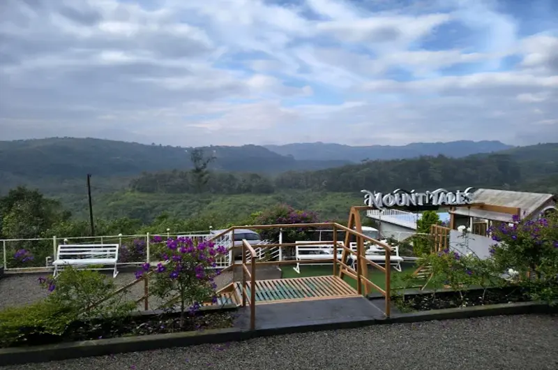 Paved driveway and entrance area of Nexstay Mount Tales hill resort in Vagamon