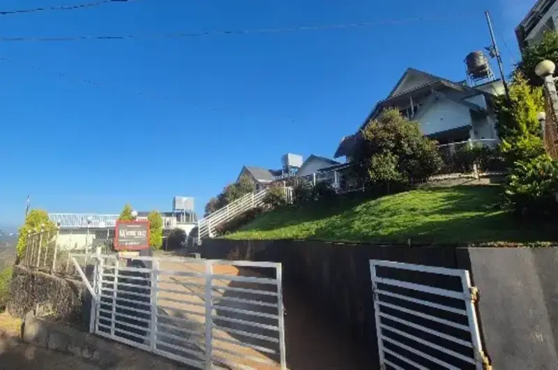 Entrance gate and pathway to Nexstay Mount Tales resort in Vagamon
