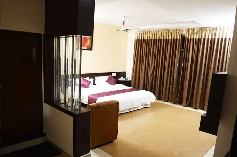 Spacious luxury bedroom suite with king bed at Mountain Mist Resort Vagamon