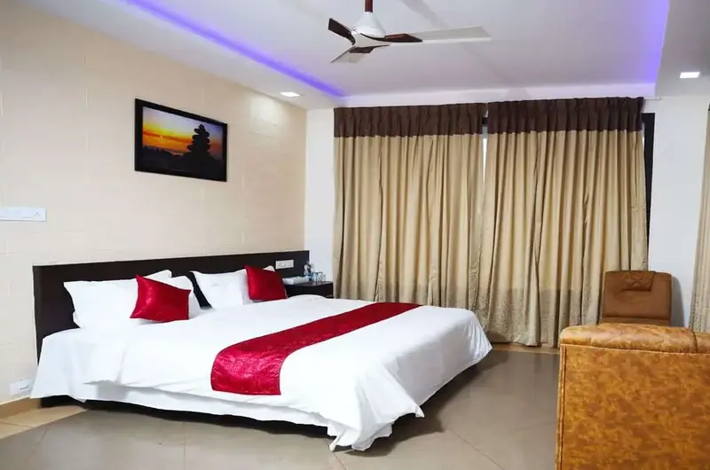 Spacious guest bedroom with plush bedding and modern lighting at Mountain Mist Resort Vagamon
