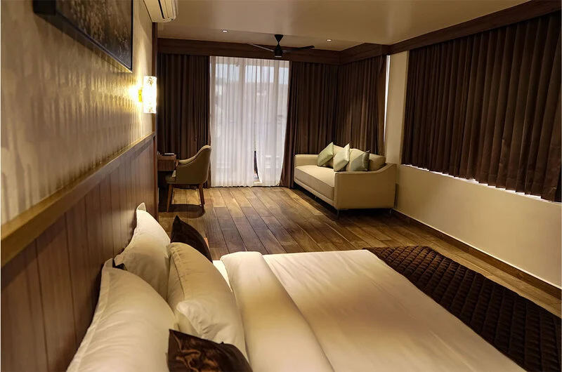 Spacious guest suite featuring plush bedding and elegant decor at Olga Resorts Vagamon