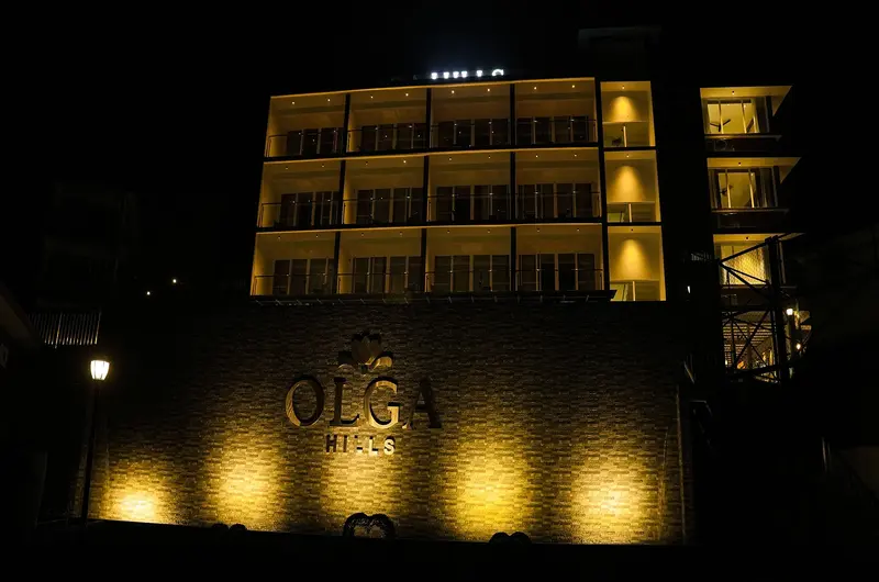 Illuminated resort building exterior lit up at night at Olga Resorts Vagamon