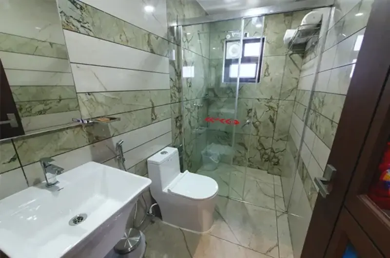 Modern resort suite bathroom with glass shower enclosure and premium vanity at The Felmel Resort