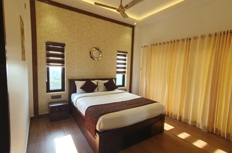 Cozy luxury resort bedroom with king-size bed and warm ambient lighting in Vagamon