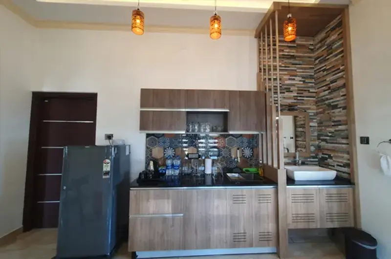 In-room kitchenette and pantry setup inside resort suite at The Felmel Resort
