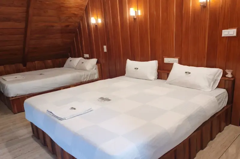 Large bedroom suite with a king-size bed and additional daybed seating at ODMOR Resort Vagamon