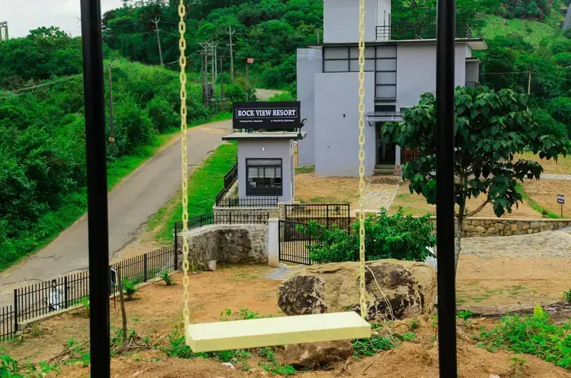 Tall outdoor rope swing on resort grounds overlooking Vagamon hills