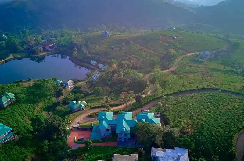Aerial view of Priyas Villa Vagamon surrounded by lush green hills
