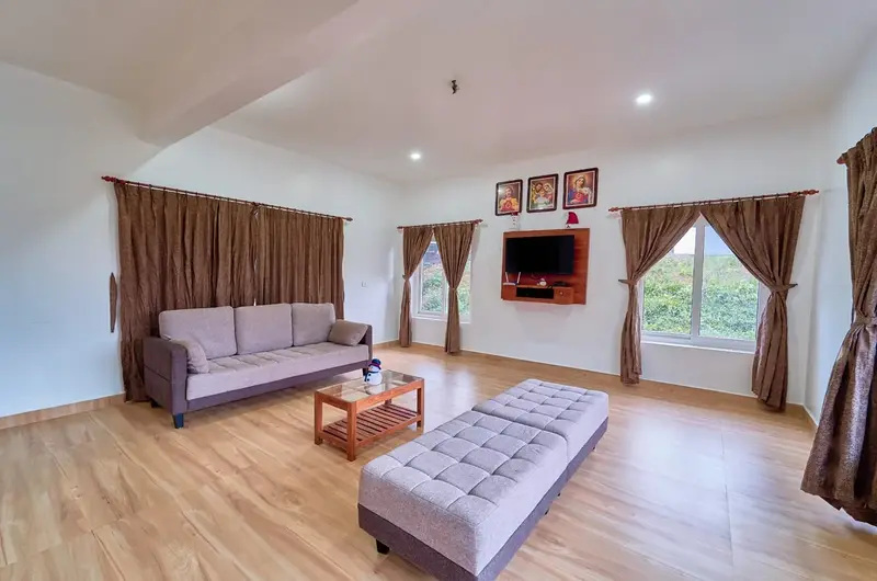 Spacious living room area with sofa seating at Priyas Villa Vagamon