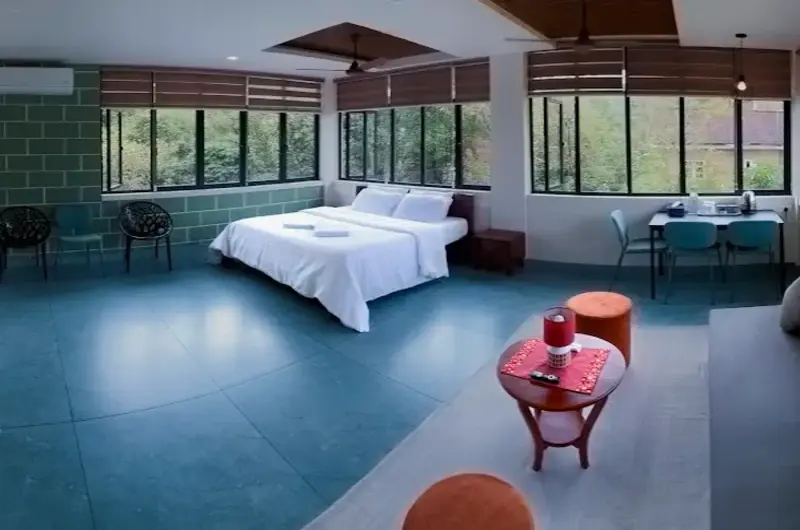 Spacious master bedroom with wooden ceiling at 8.5 Acres Vagamon