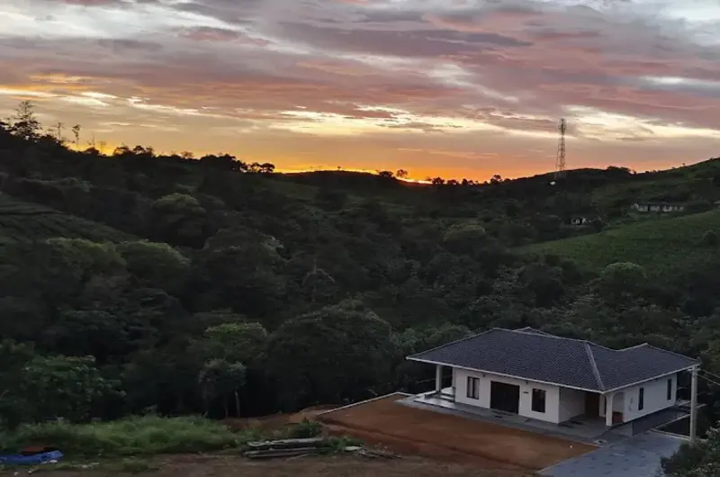 Sunset landscape view over green hills at 8.5 Acres resort Vagamon