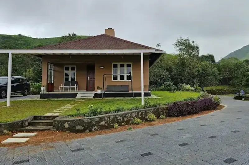 Exterior building view with paved pathway and lawn at 8.5 Acres Vagamon