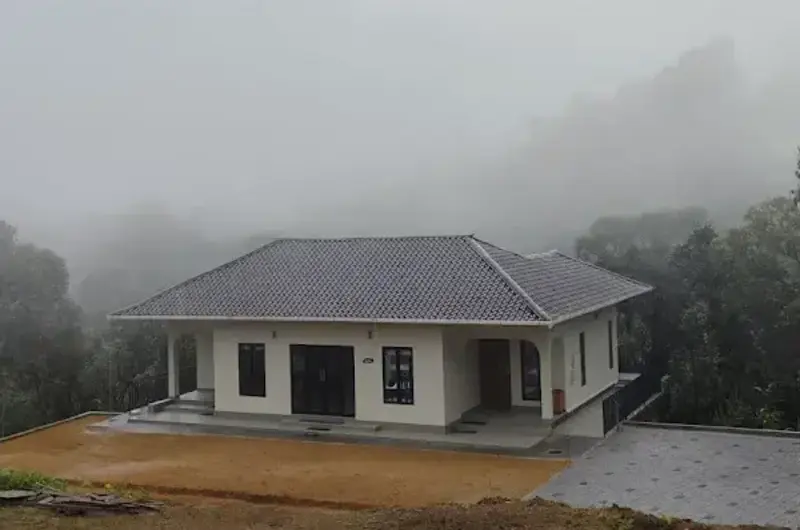 Misty morning hill view surrounding resort cottage at 8.5 Acres Vagamon