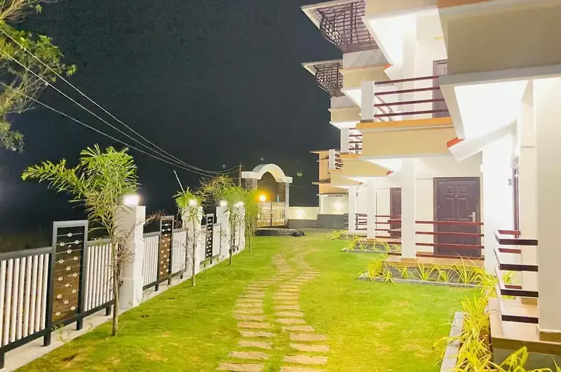 Landscaped garden walkway at Vagamon Vagashore resort at night
