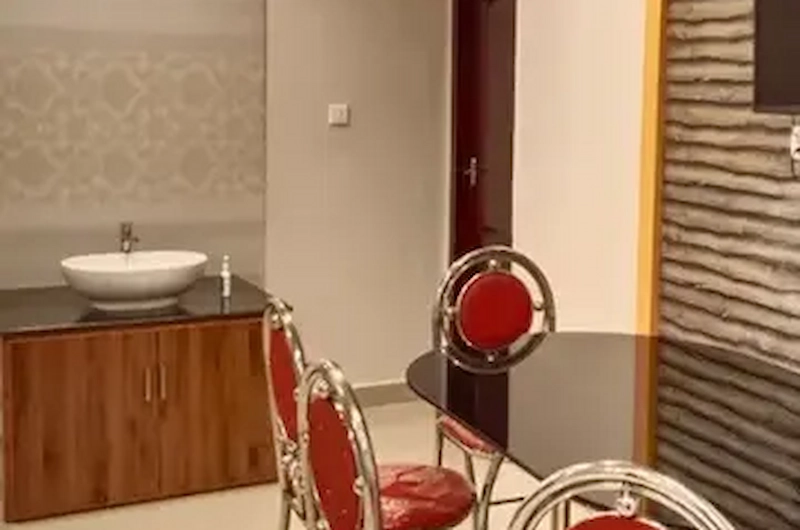 Modern vanity area with washbasin and stylish chairs at Vaga View Residency