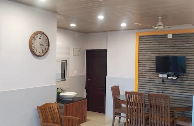 Spacious dining and living area featuring modern interior paneling at Vaga View Residency
