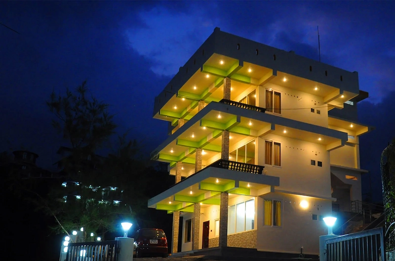 Exterior view of Vaga View Residency brightly illuminated at night