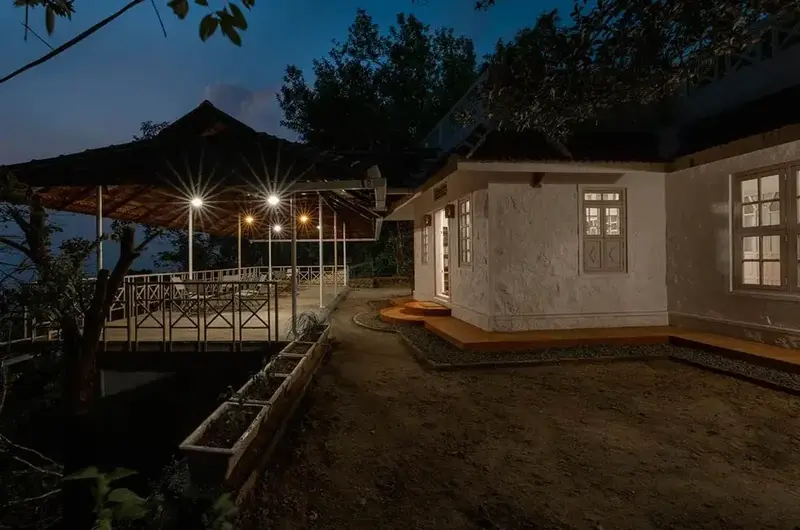 Cottage exterior illuminated at night with warm ambient lighting at Ghats Edge