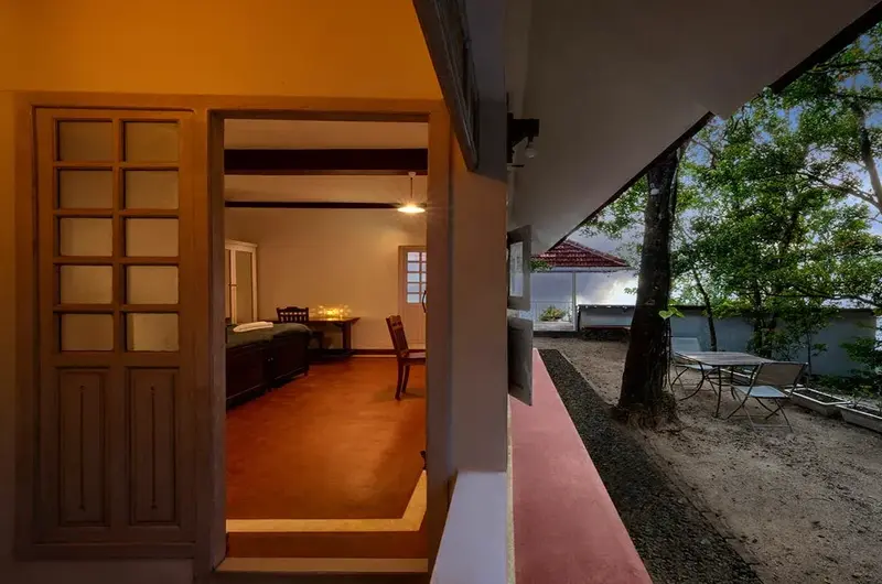 Warmly lit wooden cottage interior hallway and entryway at Ghats Edge