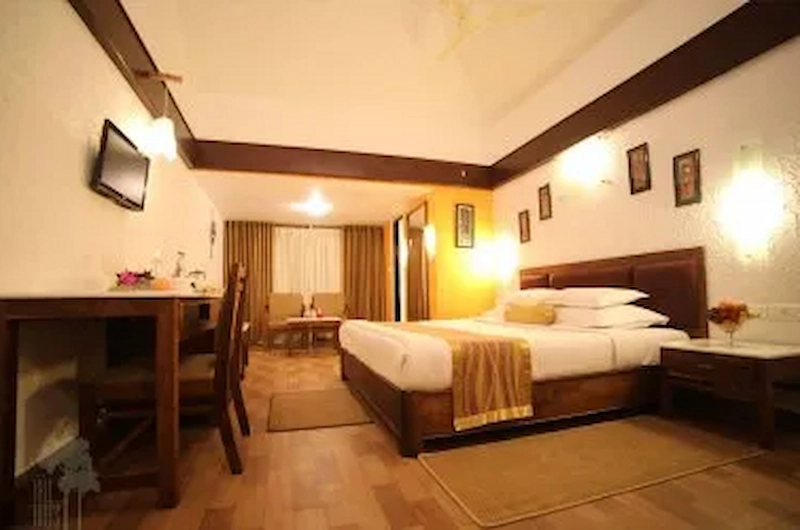Cozy resort bedroom interior with wooden finish at Pine Clough Resort Vagamon
