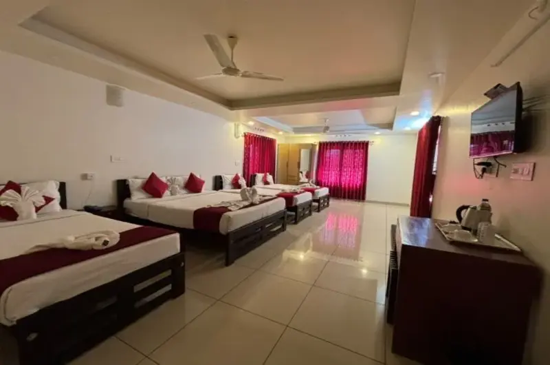 Spacious family bedroom with multiple beds at Pine Clough Resort Vagamon