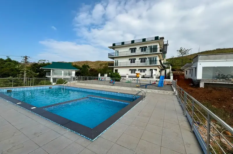 Outdoor swimming pool at Pine Clough Resort overlooking Vagamon hills