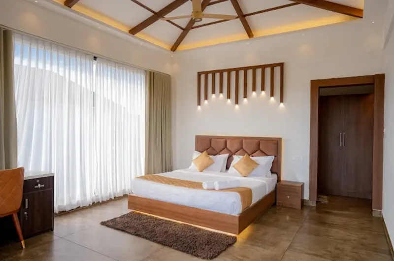 Spacious deluxe room with high sloped wooden ceiling at Golden Meadows Resort