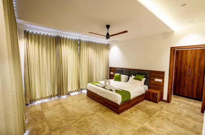 Cozy resort bedroom with false ceiling lighting at Golden Meadows Resort Vagamon