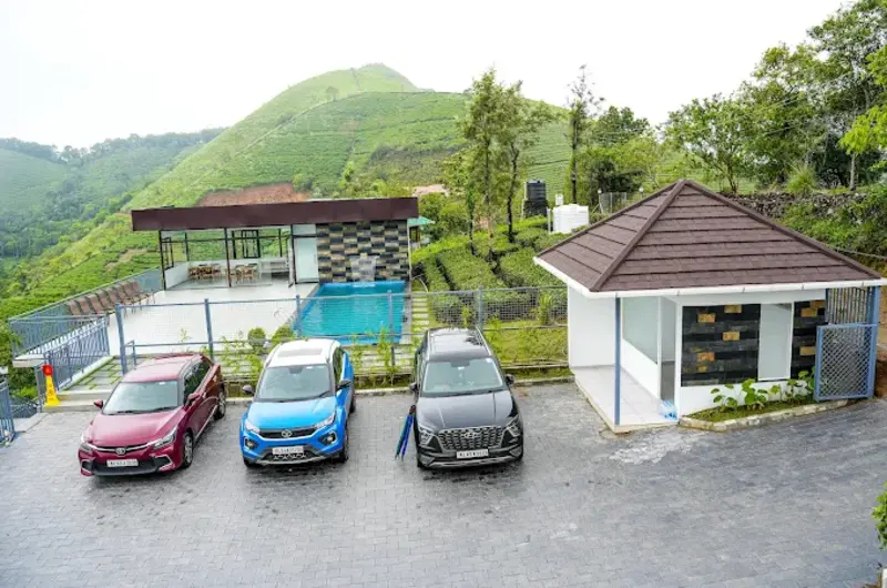 Resort cottages with guest parking area surrounded by green hills at Golden Meadows Resort