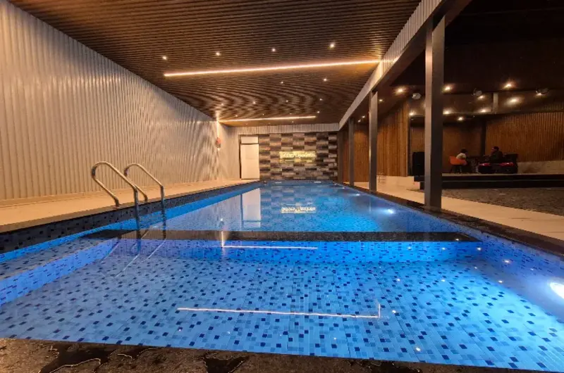 Indoor illuminated swimming pool at Golden Meadows Resort Vagamon