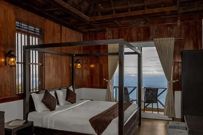Luxury suite room featuring a traditional wooden four-poster bed at Vaga Nakshathra Suites