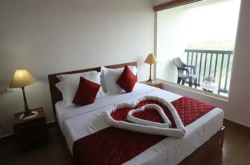 Honeymoon bed decoration with flower petals and mountain views at Vagamon Hill Chimes