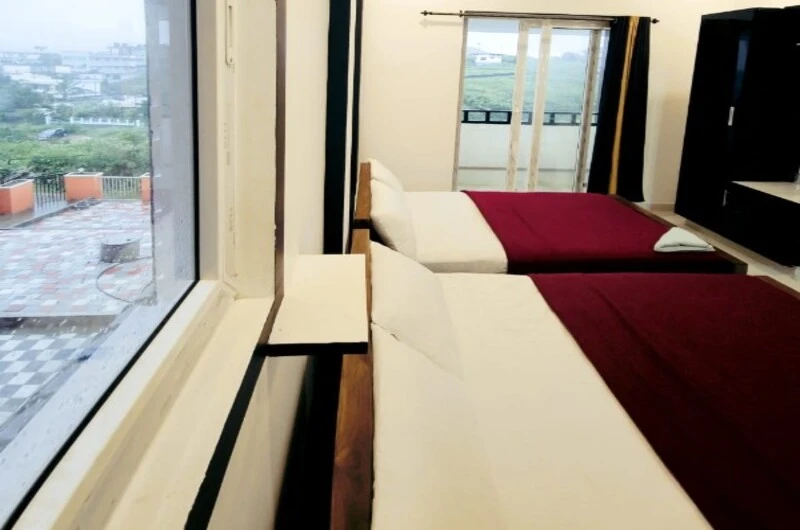 Narrow twin bed accommodation with large scenic window at Rock Lake Villa Vagamon