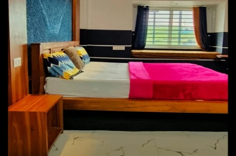 Cozy bedroom suite with vibrant bedding and wooden headboard at Rock Lake Villa