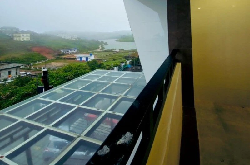 Private glass canopy balcony with scenic valley view at Rock Lake Villa