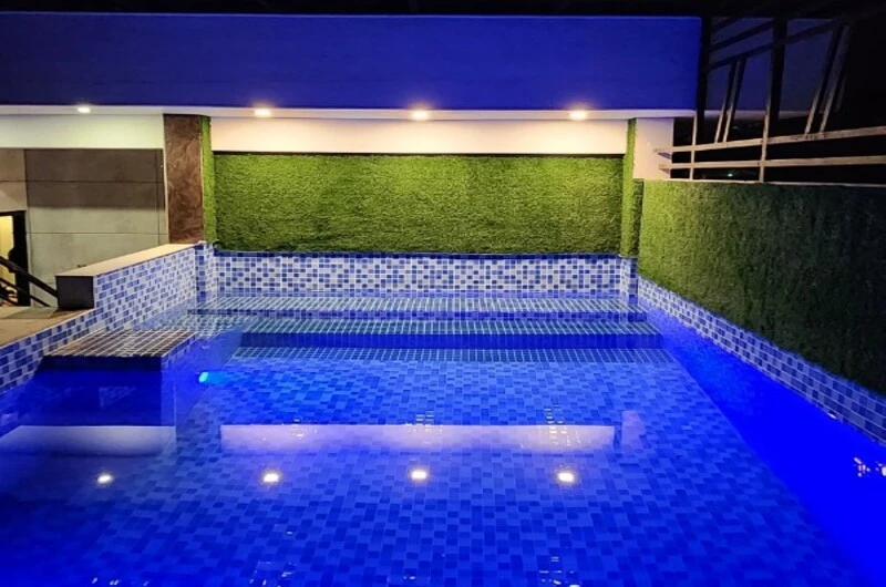 outdoor swimming pool lit up at night at Rock Lake Villa